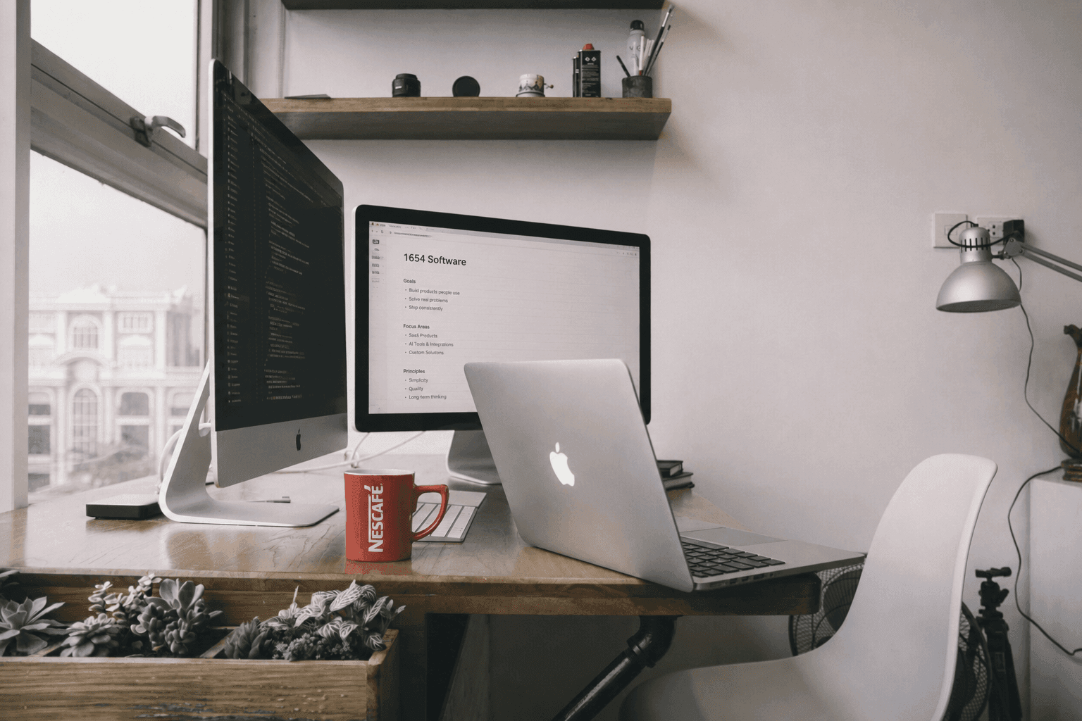 Developer workspace with monitors and laptop